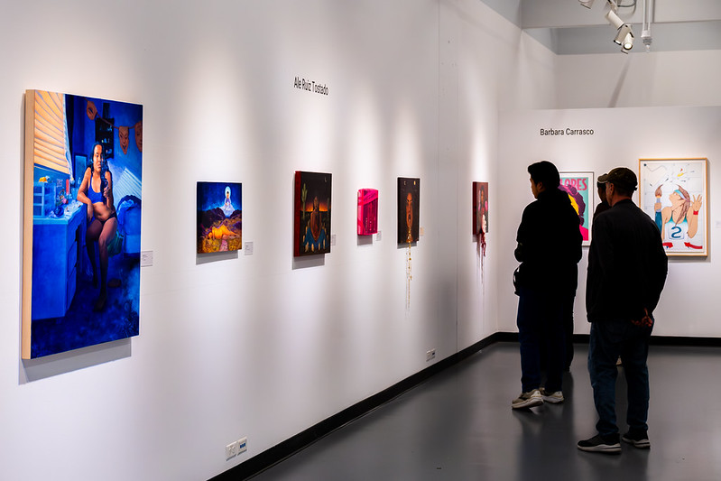 Guest viewing paintings from Politics of Portrayal