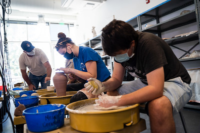 ceramic students using pottery wheel
