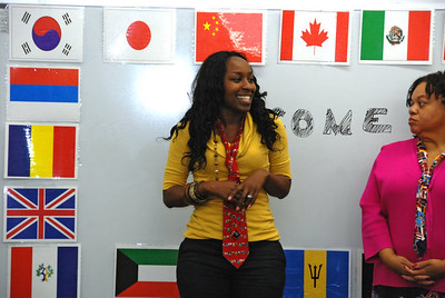 person posing behind international flags