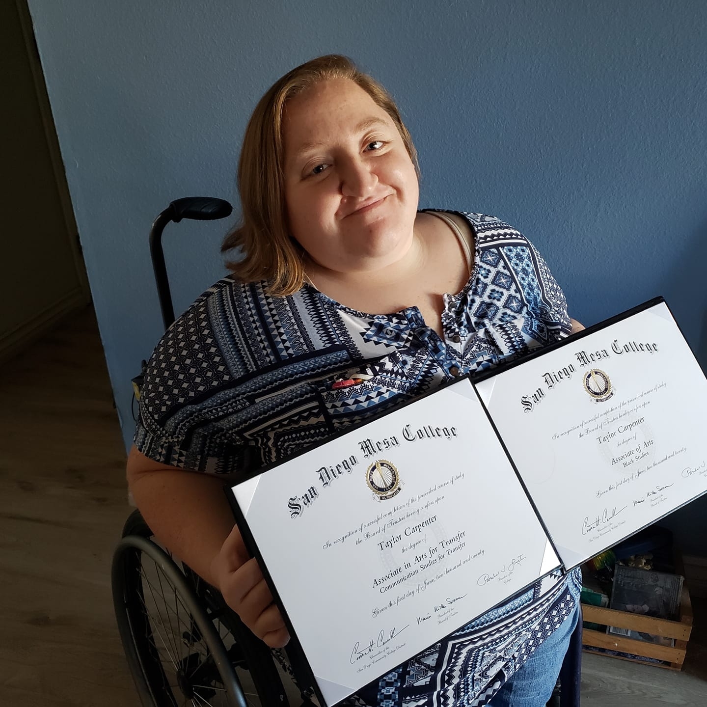 Taylor Carpenter holding two associate’s degree certificates from Mesa College.